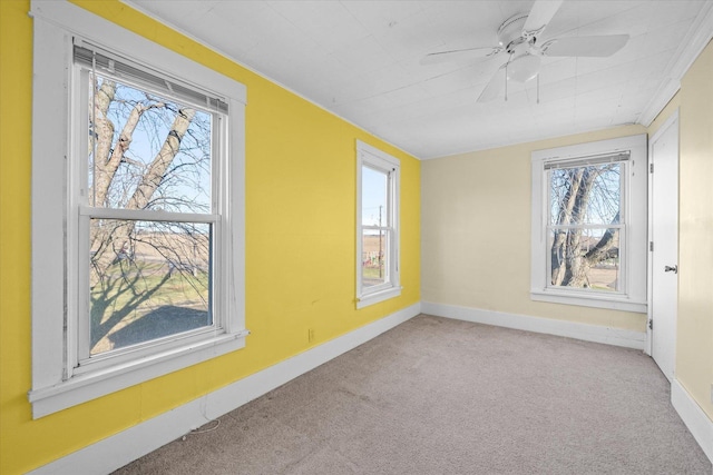 carpeted empty room featuring a wealth of natural light and ceiling fan