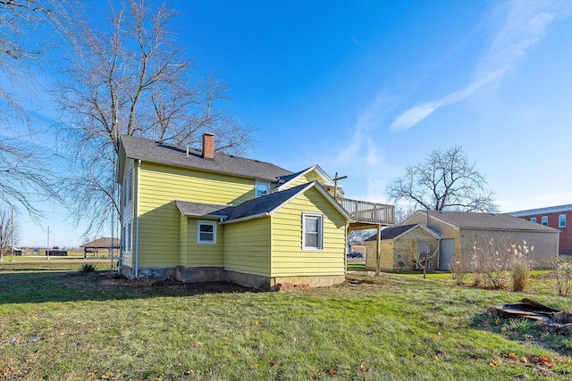 rear view of house featuring a yard