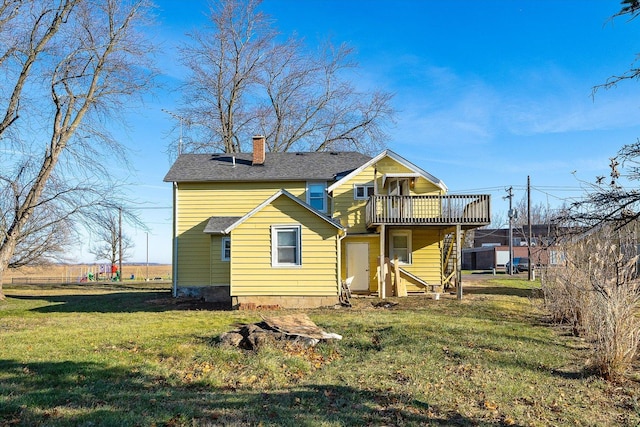 back of house with a wooden deck and a yard