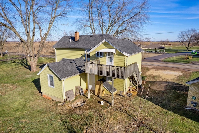 back of property featuring a lawn and a wooden deck