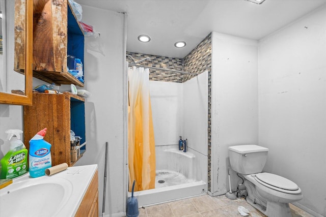 bathroom with tile patterned flooring, vanity, toilet, and curtained shower