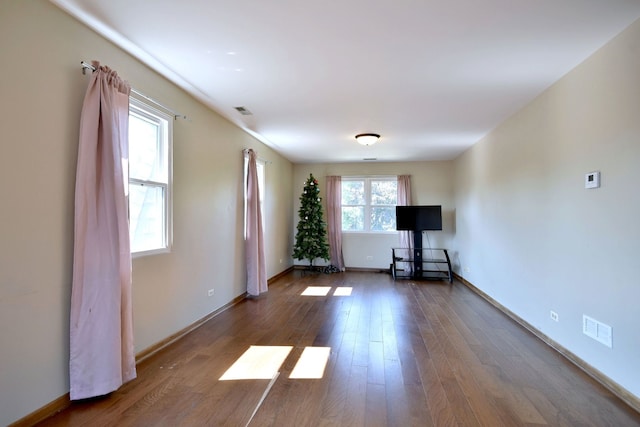 unfurnished living room with wood-type flooring