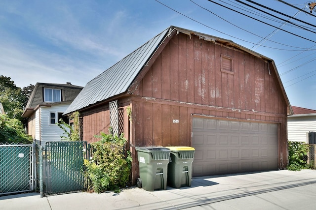 view of side of property with an outdoor structure and a garage