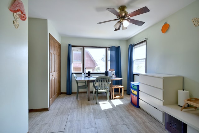 home office with ceiling fan, light hardwood / wood-style flooring, and plenty of natural light