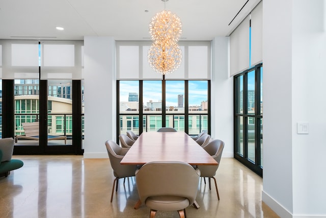 dining room featuring expansive windows, french doors, and a chandelier