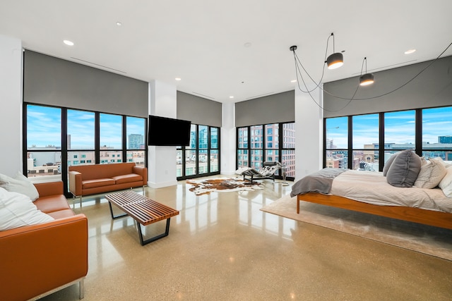 bedroom featuring multiple windows and a towering ceiling