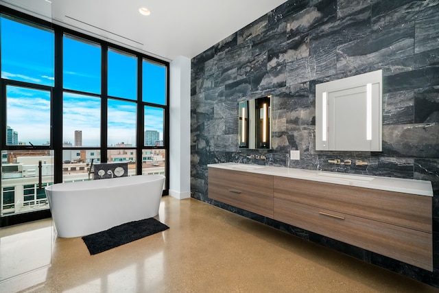 bathroom with backsplash, a bathing tub, and vanity