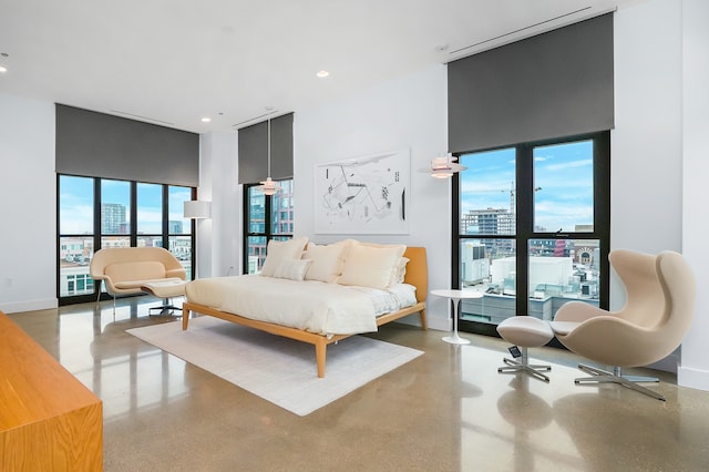 bedroom with a towering ceiling and concrete floors