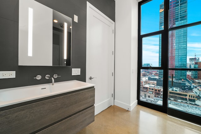 bathroom with vanity and concrete flooring