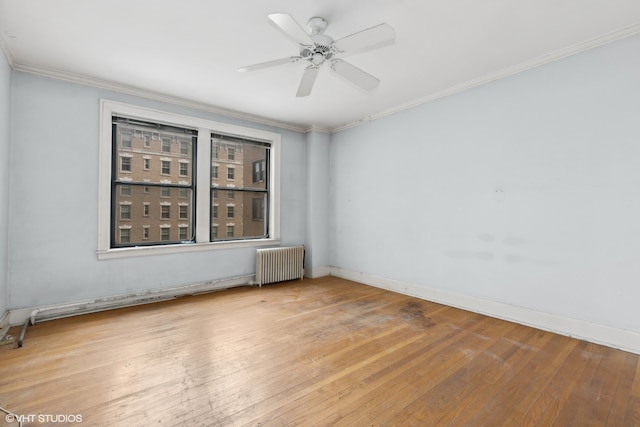 empty room with radiator heating unit, ornamental molding, ceiling fan, and hardwood / wood-style floors