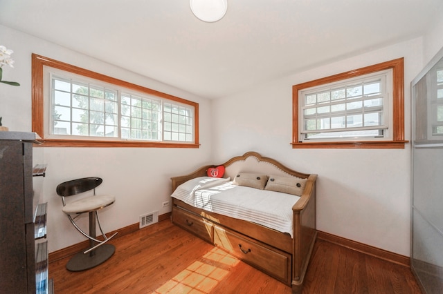 bedroom with hardwood / wood-style floors