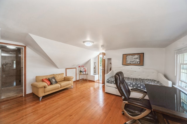 bedroom with light hardwood / wood-style flooring and vaulted ceiling