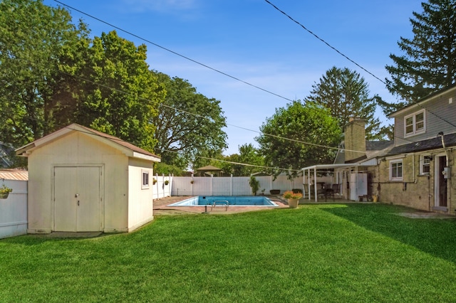 view of yard with a fenced in pool and a storage shed