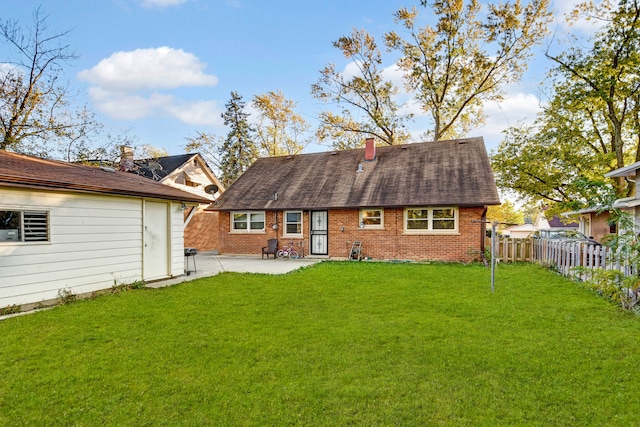 back of house with a patio and a lawn