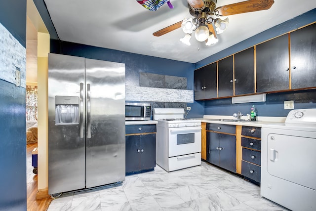 kitchen featuring washer / dryer, stainless steel appliances, sink, and ceiling fan