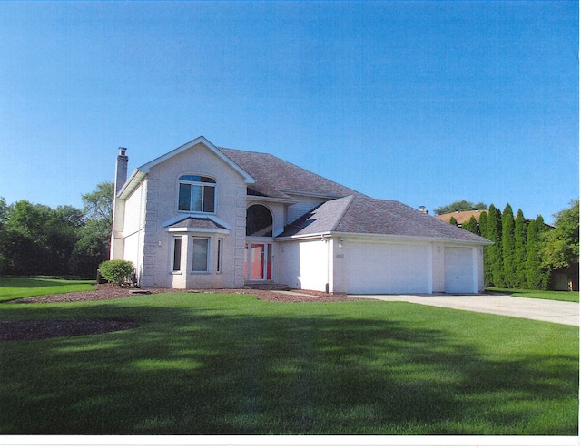 view of front of home featuring a front lawn and a garage