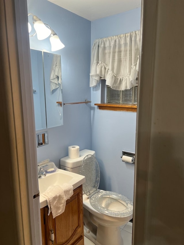 bathroom with tile patterned floors, toilet, and vanity