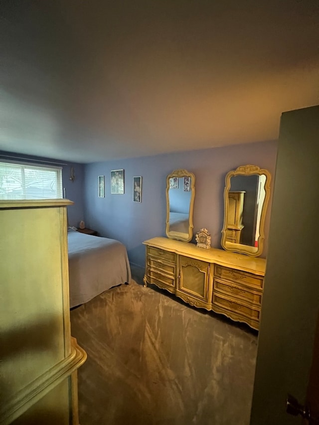 bedroom with dark colored carpet