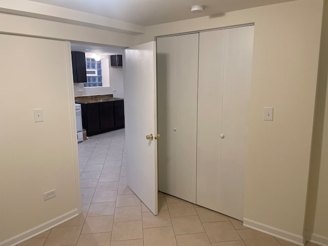 interior space featuring a closet and light tile patterned floors