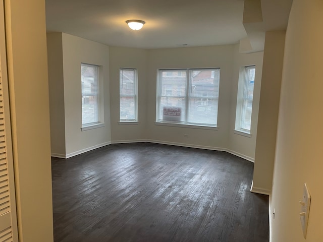 empty room with dark hardwood / wood-style floors