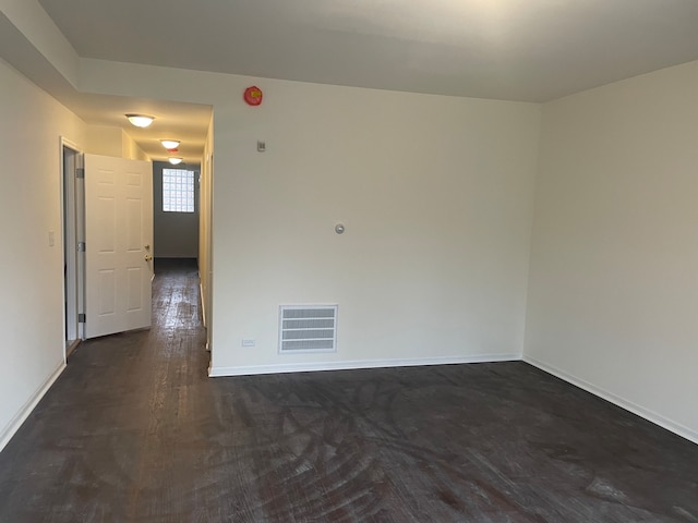 empty room featuring dark wood-type flooring