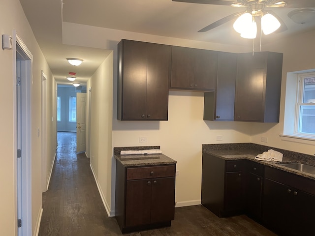 kitchen featuring dark brown cabinets, ceiling fan, and dark wood-type flooring