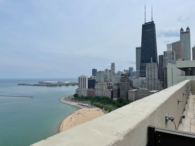 property's view of city featuring a view of the beach and a water view