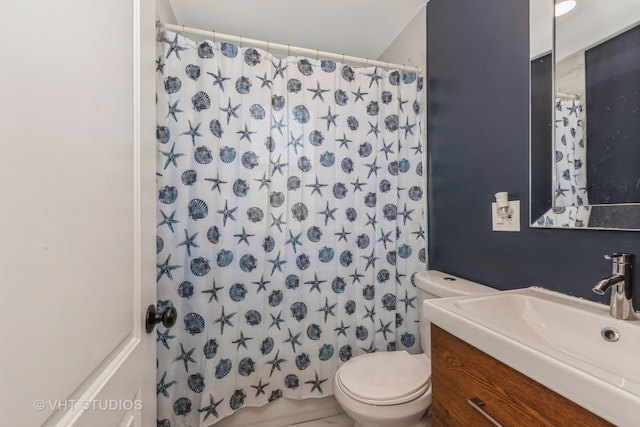 bathroom with vanity, toilet, and walk in shower