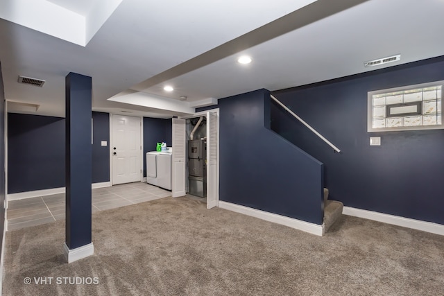 basement featuring washer and clothes dryer and carpet flooring