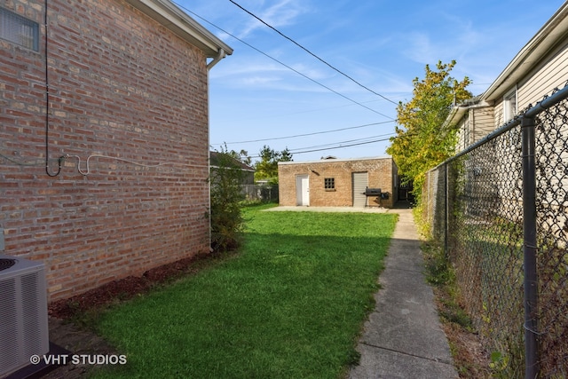 view of yard featuring central AC and an outbuilding