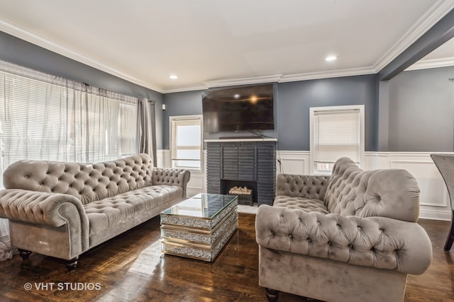 living room with dark hardwood / wood-style flooring, ornamental molding, and a brick fireplace