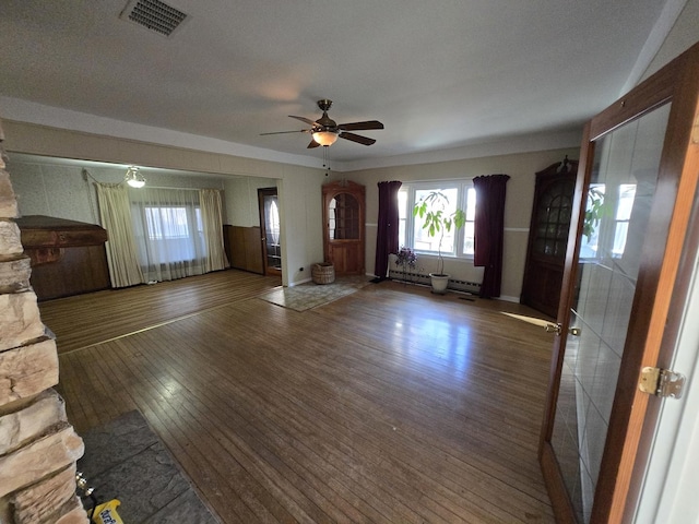 unfurnished living room featuring ceiling fan, dark hardwood / wood-style flooring, and a textured ceiling