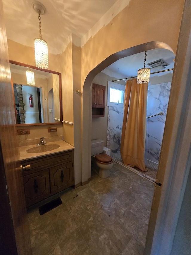 bathroom with vanity, toilet, and walk in shower