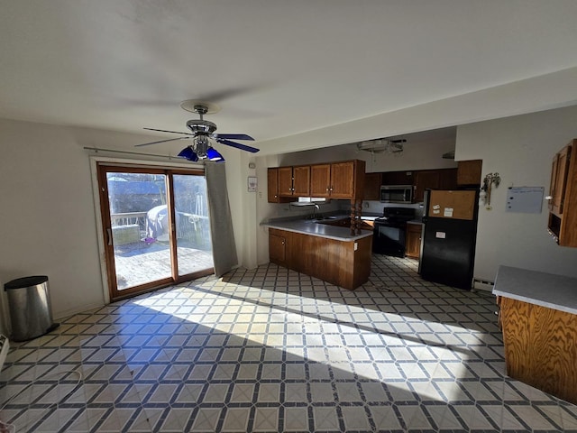 kitchen featuring kitchen peninsula, ceiling fan, and black appliances