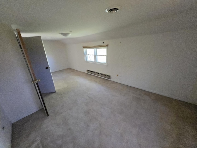 carpeted spare room featuring a baseboard radiator