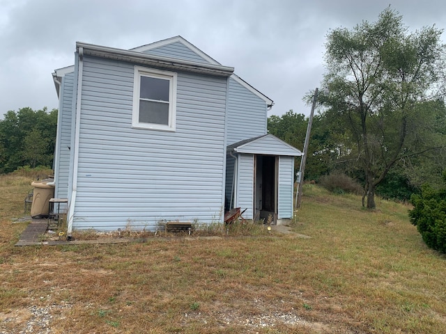 view of side of home featuring a yard