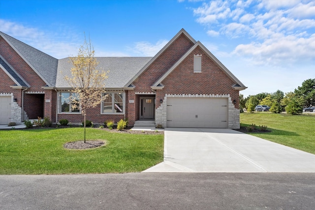 view of front of property with a front yard and a garage