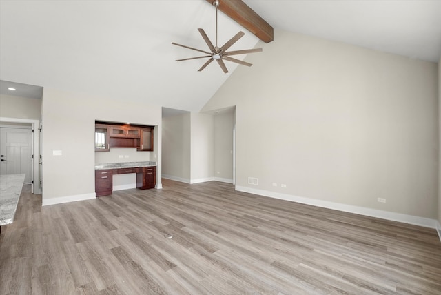 unfurnished living room with built in desk, high vaulted ceiling, beamed ceiling, light wood-type flooring, and ceiling fan