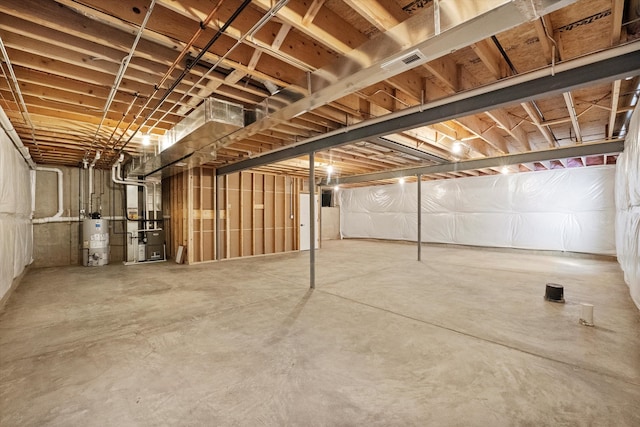 basement with gas water heater and heating unit