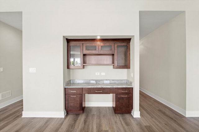 kitchen featuring light stone countertops and hardwood / wood-style floors