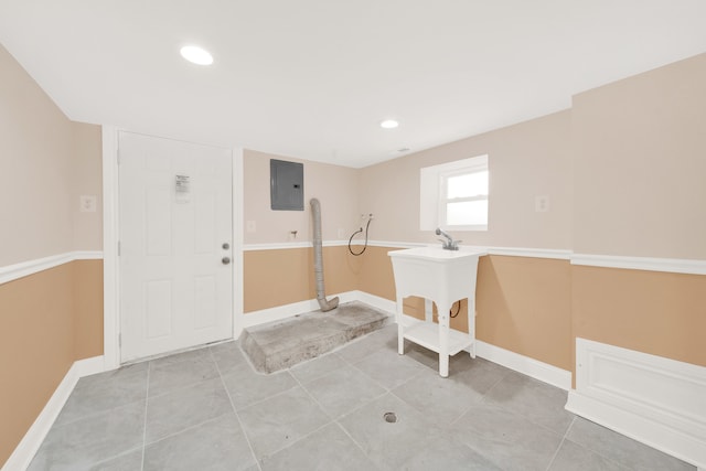 washroom with electric panel and tile patterned floors