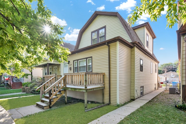 view of front of house with central air condition unit and a front yard