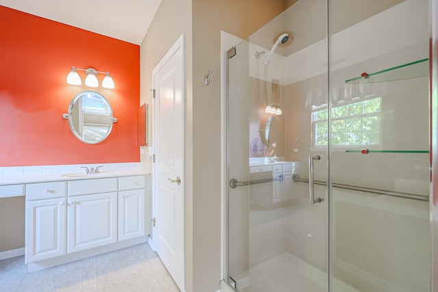 bathroom featuring vanity and an enclosed shower