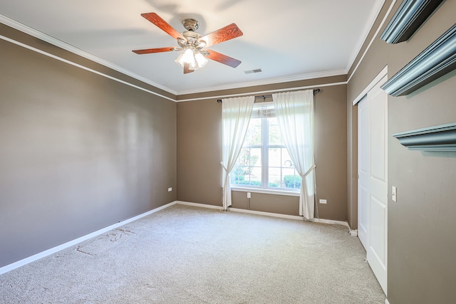 unfurnished bedroom with crown molding, light carpet, and ceiling fan