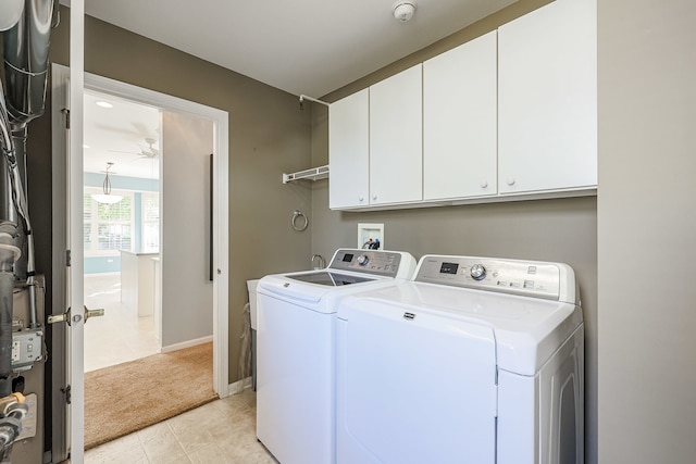 laundry area with ceiling fan, light tile patterned floors, cabinets, and washer and dryer