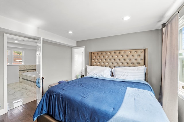 bedroom with dark hardwood / wood-style floors and ensuite bathroom