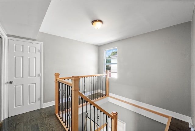 corridor with dark hardwood / wood-style flooring