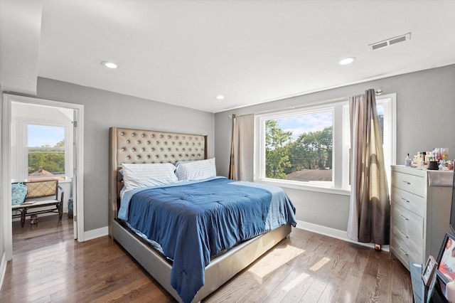 bedroom with wood finished floors, baseboards, and recessed lighting