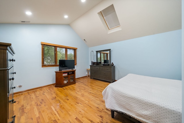 bedroom with light wood-type flooring and lofted ceiling