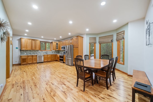 dining area with sink and light hardwood / wood-style floors